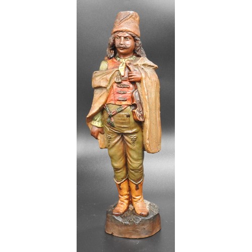 311 - A PAINTED POTTERY FIGURE, LATE 19TH/EARLY 20TH CENTURY, of a Moorish gypsy violinist, modelled stand... 