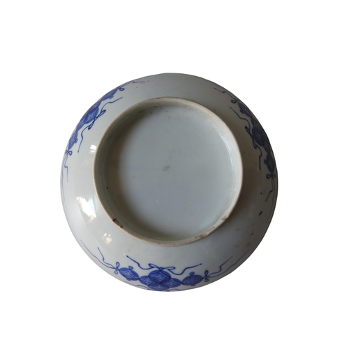 294 - A JAPANESE BLUE AND WHITE DISH19/20TH CENTURY underglaze blue flowers growing on rocks.