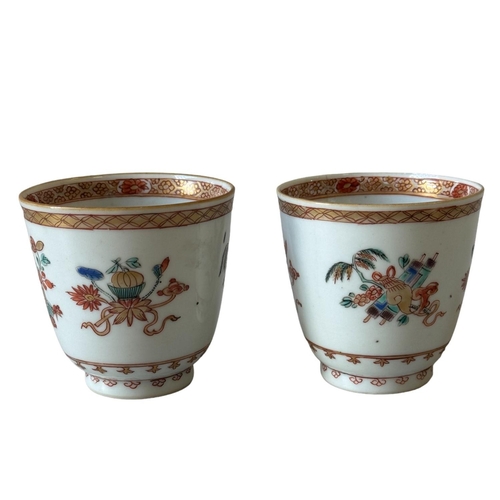 296 - A PAIR OF FAMILLE ROSE CUP18TH CENTURY decorated with auspicious symbols and floral motifs.... 