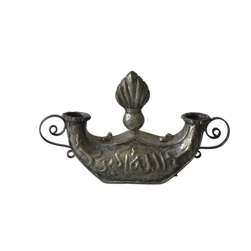 216 - A PERSIAN WHITE METAL CANDLE HOLDER, EARLY 20TH CENTURY, surmounted by a central finial with two scr... 
