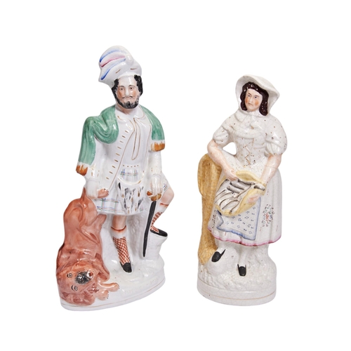 317 - A VICTORIAN STAFFORDSHIRE FIGURE OF ‘THE LION SLAYER’ and another of the ‘Fish Wife’.40 cms max... 