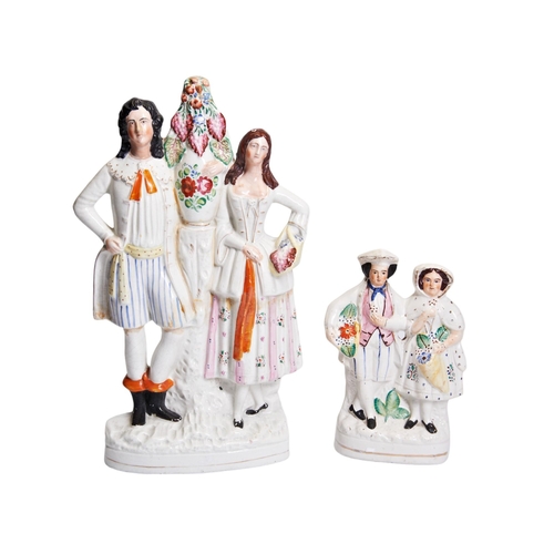 322 - A LARGE VICTORIAN STAFFORDSHIRE FIGURE GROUP OF A MAN AND A WOMAN FLANKING A FOLIATE VASE ON A PEDES... 