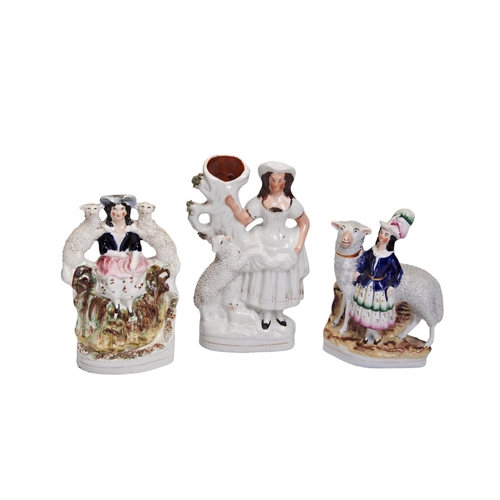 323 - A VICTORIAN STAFFORDSHIRE FIGURE OF A GIRL WITH A LARGE SHEEP and two other figure groups with sheep... 