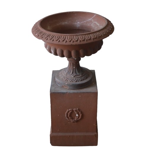 126 - A TERRACOTTA COLOUR CAST GARDEN URN ON STAND, 20TH CENTURY, in three sections, the gadrooned edge fl... 