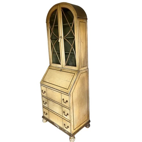 12 - AN EARLY 20TH CENTURY PAINTED BUREAU, arched top section with two glazed cabinet doors enclosing two... 