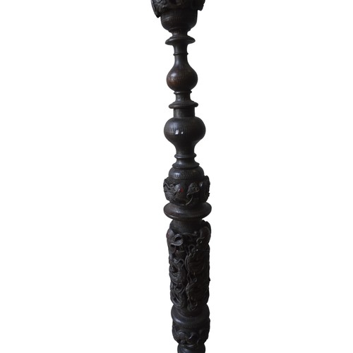 208 - AN ORNATE CARVED BURMESE FLOOR LAMP, the turned pillar and domed circular base profusely carved with... 