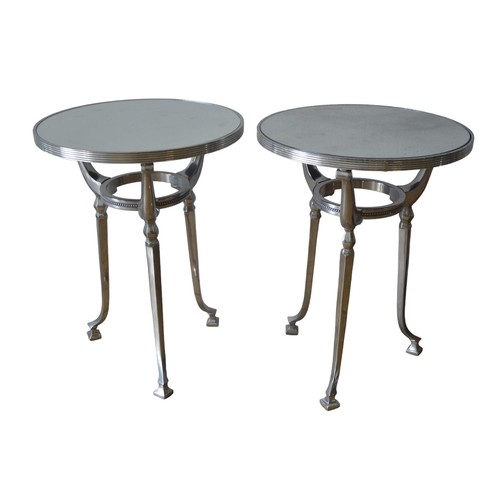 16 - A PAIR OF CONTEMPORARY MIRROR TOP TRIPOD TABLES, the circular tops inset with distressed mirror plat... 