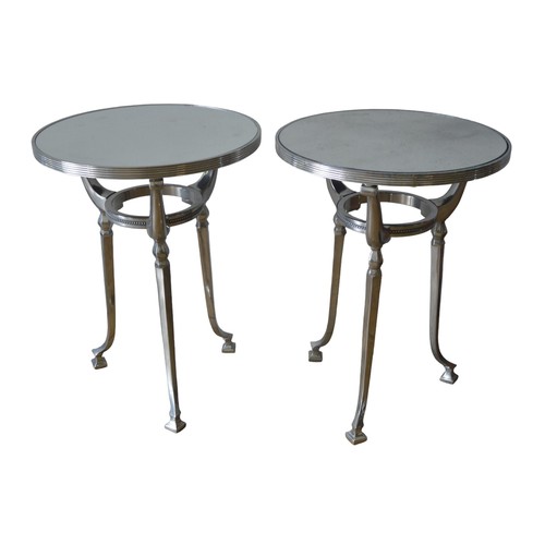 16 - A PAIR OF CONTEMPORARY MIRROR TOP TRIPOD TABLES, the circular tops inset with distressed mirror plat... 