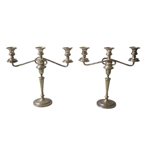 447A - A PAIR OF SILVER CANDLESTICKS, 1909, surmounted by associated silver plated scrolling triple sconce ... 