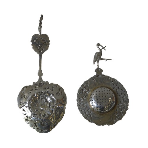 441A - AN ORNATE DUTCH SILVER SUGAR SPOON AND TEA STRAINER, both with ornate pierced chased decoration, the... 