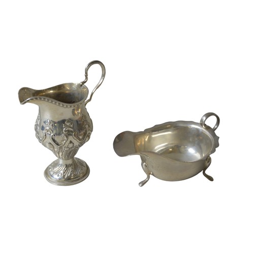 439A - A REPOUSSE DECORATED SILVER CREAM JUG, with scroll handle, marked Marton & Bayliss, Birmingham, ... 