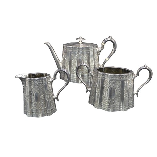 794 - A VICTORIAN SILVER THREE PIECE TEA SET, undulating oval form with ornate repousse decoration and scr... 