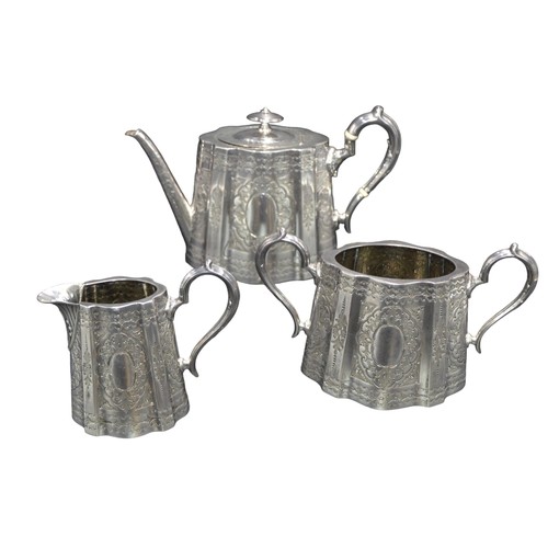 794 - A VICTORIAN SILVER THREE PIECE TEA SET, undulating oval form with ornate repousse decoration and scr... 