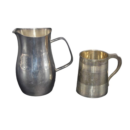 801 - A SILVER MILK JUG AND CHRISTENING TANKARD, the plain waisted jug marked London 1975 (10.5 cm high, 2... 