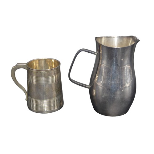 801 - A SILVER MILK JUG AND CHRISTENING TANKARD, the plain waisted jug marked London 1975 (10.5 cm high, 2... 