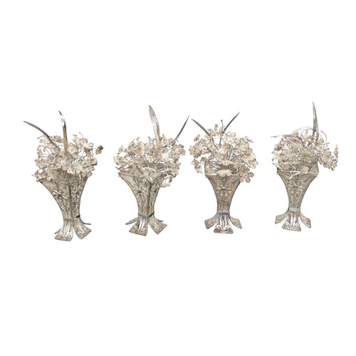 825 - A GROUP OF FOUR PERSIAN FILIGREE FLORAL ARRANGEMENTS, mounted in tapering square form filigree vases... 