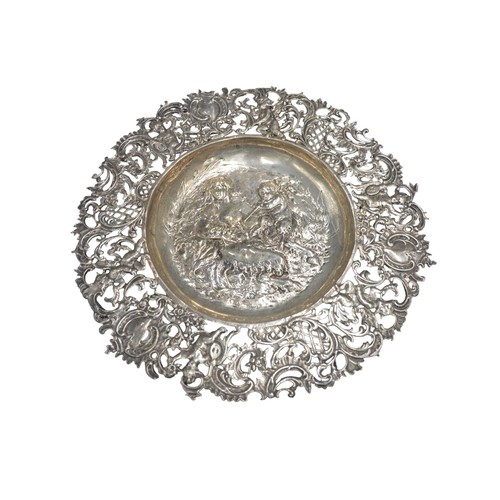 450A - 19TH CENTURY HANAU SILVER DISH, having pierced Rococo border and central embossed well depicting sat... 