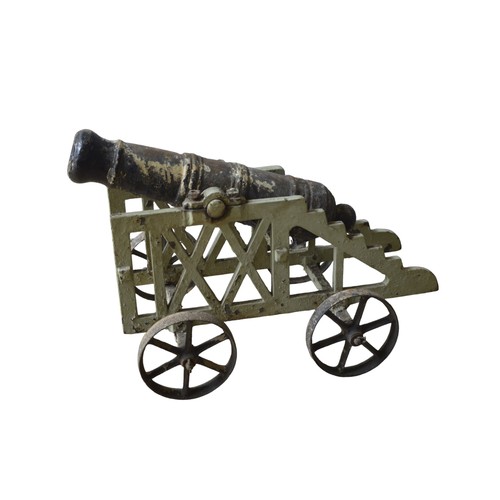 134 - AN ORNAMENTAL CANNON WITH ASSOCIATED CARRIAGE86 x 51 cm