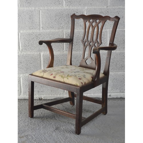 519 - A MAHOGANY ELBOW CHAIR, IN THE CHIPPENDALE MANNER, undulating top rail over a pierced lattice splat,... 