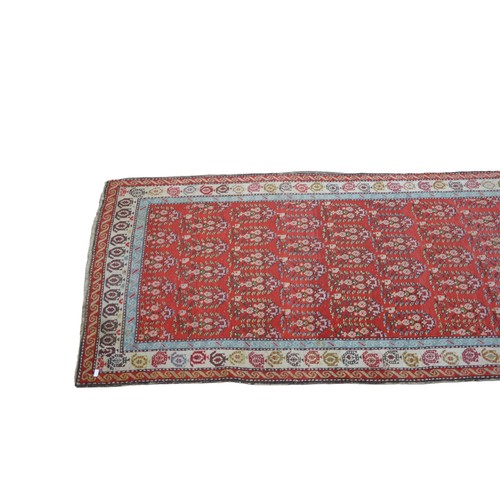 148 - A HAND KNOTTED PERSIAN RUNNER, EARLY 2OTH CENTURY, deep border pattern on a rich red ground480 x 104... 