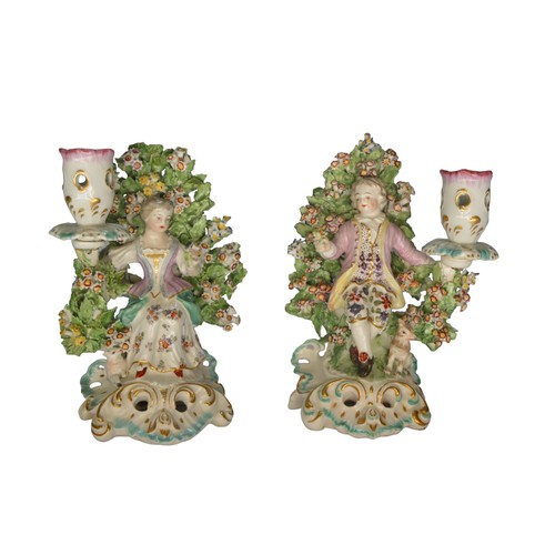 306 - A PAIR OF DERBY BOCAGE CANDLESTICKS, LATE 18TH CENTURY, of shepherd and shepherdess, raised on pierc... 