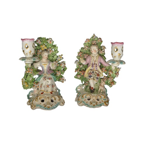 306 - A PAIR OF DERBY BOCAGE CANDLESTICKS, LATE 18TH CENTURY, of shepherd and shepherdess, raised on pierc... 