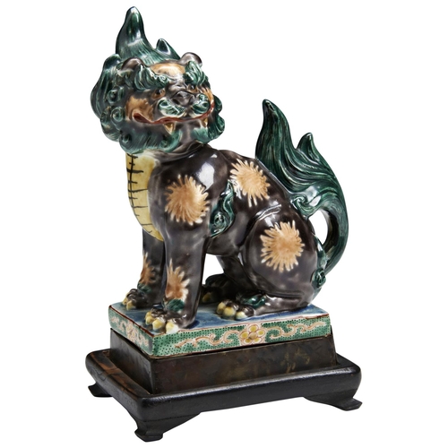 112 - A JAPANESE KUTANI LIONMEIJI PERIOD (1868-1911)raised on a hardwood base16.5cm high PROVENANCE: From ... 