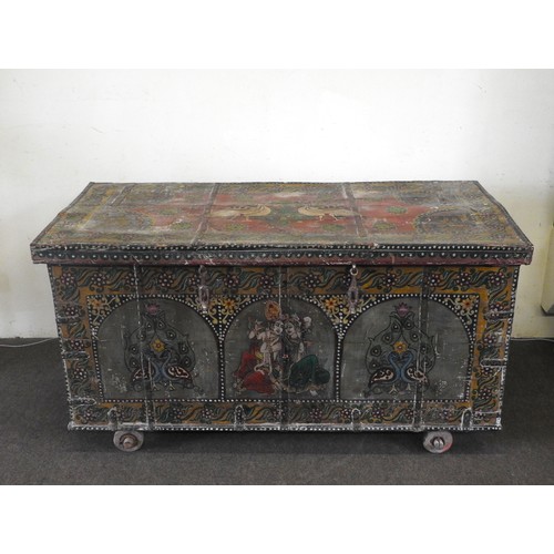 33 - A LARGE INDIAN TEAK SANDOOK CHEST, the iron banded teak chest profusely painted with hindu deities a... 