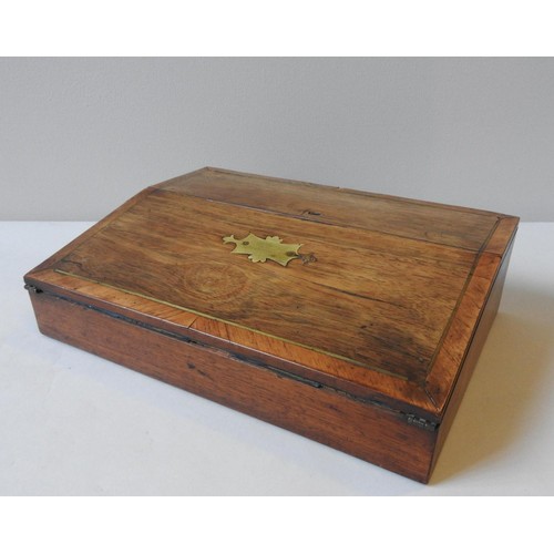 507 - A 19TH CENTURY CROSS BANDED MAHOGANY WRITING SLOPE, the brass inlay bi-fold lid opening to reveal a ... 