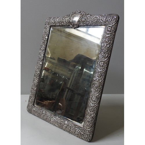 595 - A LARGE SILVER FRAMED TABLE MIRROR, 19TH CENTURY, original bevelled plate within a cushion form fram... 