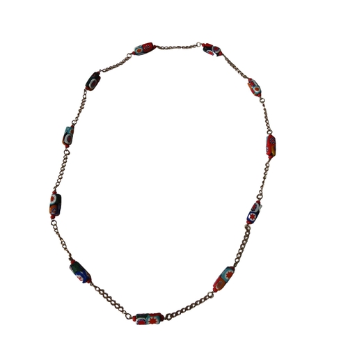 530 - MURANO GLASS NECKLACE, the eleven beads with bright abstract decoration on a gilt chain.Total weight... 