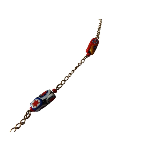 530 - MURANO GLASS NECKLACE, the eleven beads with bright abstract decoration on a gilt chain.Total weight... 