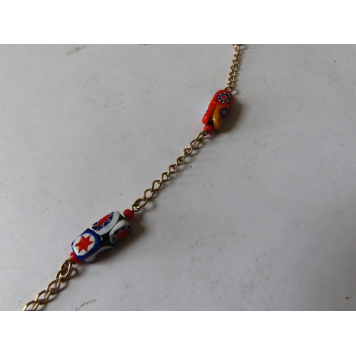 530 - MURANO GLASS NECKLACE, the eleven beads with bright abstract decoration on a gilt chain.Total weight... 