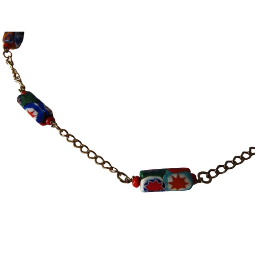 530 - MURANO GLASS NECKLACE, the eleven beads with bright abstract decoration on a gilt chain.Total weight... 