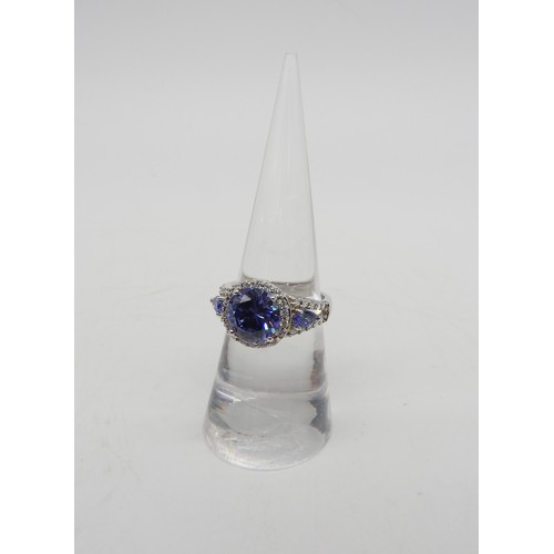 548 - A SILVER CZ AND BLUE STONE SET FASHION RING