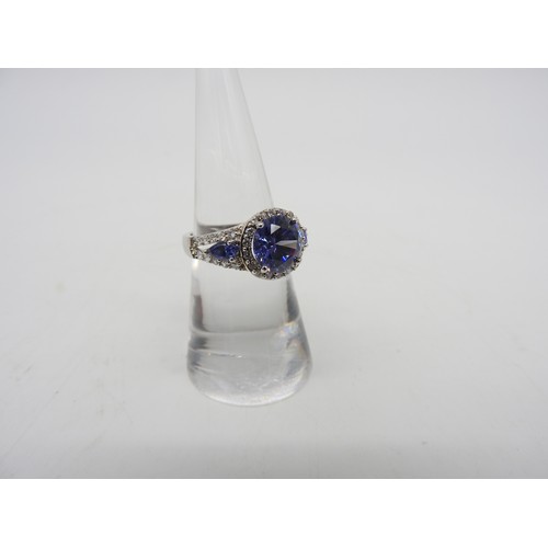 548 - A SILVER CZ AND BLUE STONE SET FASHION RING