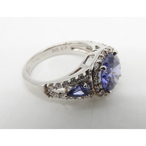 548 - A SILVER CZ AND BLUE STONE SET FASHION RING