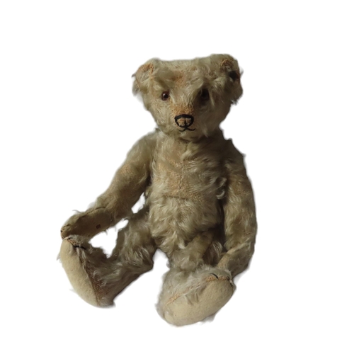 A VINTAGE STEIFF BEAR, CIRCA 1925, with golden mohair, pronounced muzzle, black stitched nose, mouth and claws, jointed limbs with felt pads