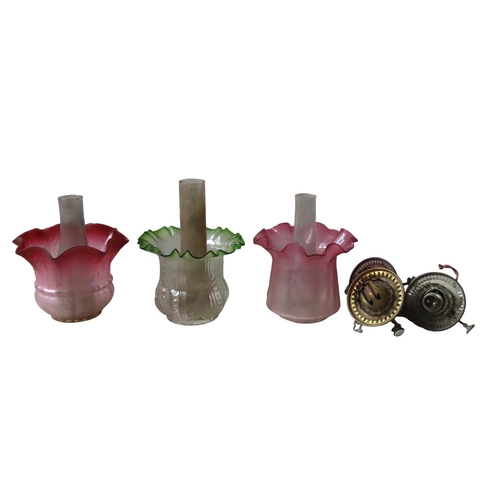 325 - THREE 19TH CENTURY COLOURED GLASS OIL LAMP SHADES, with associated chimneys