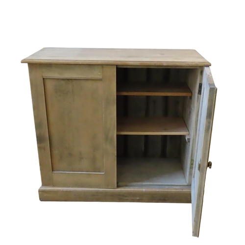 24 - A VINTAGE PINE SIDE CUPBOARD, plain rectangular form with twin panelled doors enclosing two interior... 