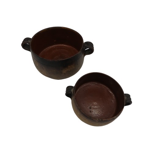 303 - TWO VINTAGE VALLAURIS EARTHENWARE COOKING POTS, with glazed interiors and applied ring handles, both... 