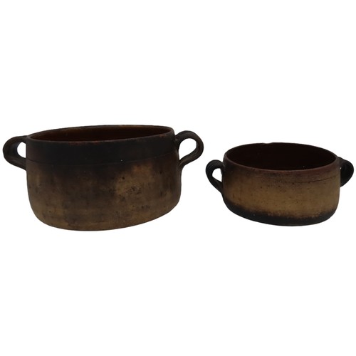 303 - TWO VINTAGE VALLAURIS EARTHENWARE COOKING POTS, with glazed interiors and applied ring handles, both... 