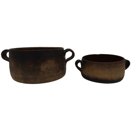 303 - TWO VINTAGE VALLAURIS EARTHENWARE COOKING POTS, with glazed interiors and applied ring handles, both... 