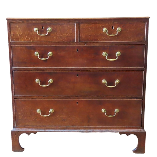 65 - A GEORGE III OAK CHEST OF DRAWERS, CIRCA 1810, comprised of two short drawers over three long gradua... 