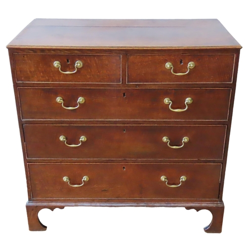 65 - A GEORGE III OAK CHEST OF DRAWERS, CIRCA 1810, comprised of two short drawers over three long gradua... 