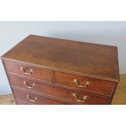 65 - A GEORGE III OAK CHEST OF DRAWERS, CIRCA 1810, comprised of two short drawers over three long gradua... 