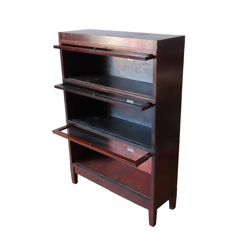 34 - A VINTAGE GLOBE WERNICKE 'UNIVERSAL' ELASTIC BOOKCASE, comprised of three stacking sections with gla... 