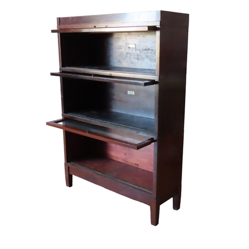 34 - A VINTAGE GLOBE WERNICKE 'UNIVERSAL' ELASTIC BOOKCASE, comprised of three stacking sections with gla... 