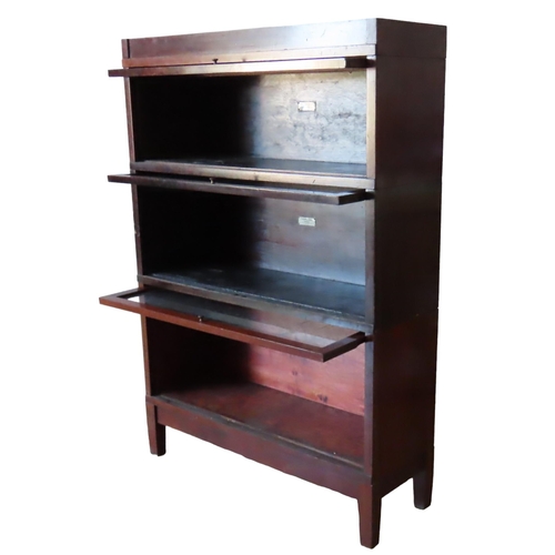 34 - A VINTAGE GLOBE WERNICKE 'UNIVERSAL' ELASTIC BOOKCASE, comprised of three stacking sections with gla... 