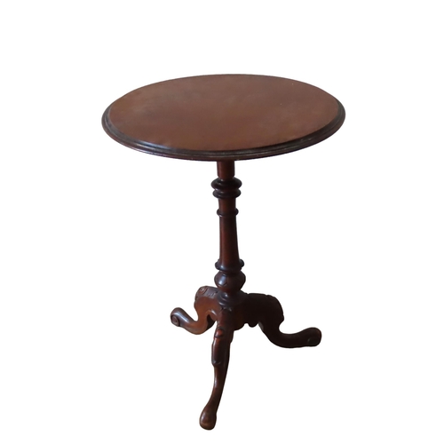 55 - A LATE 19TH CENTURY MAHOGANY LAMP TABLE, moulded edge circular top on a ring turned tulip carved col... 